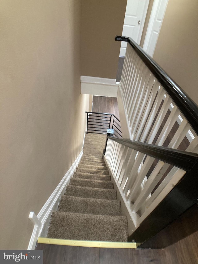 staircase with carpet and baseboards