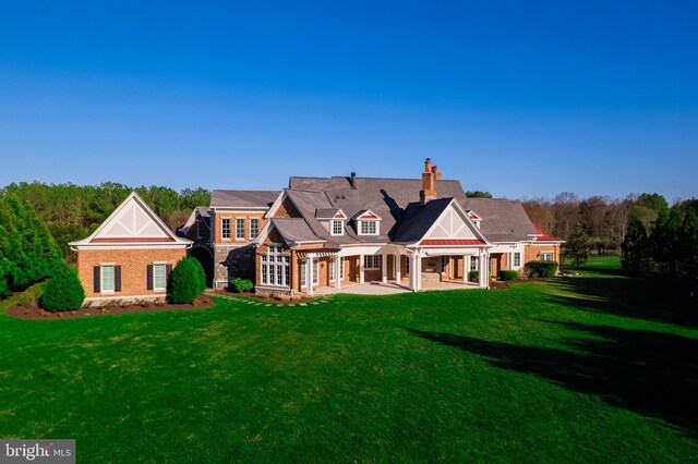 22577 Creighton Farms Dr, Leesburg, VA 20175 - rear view of property with a patio area, a lawn, and a chimney