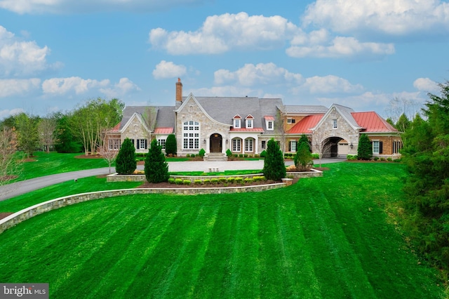 22577 Creighton Farms Dr, Leesburg, VA 20175 - view of front of house with a standing seam roof, stone siding, metal roof, curved driveway, and a front lawn