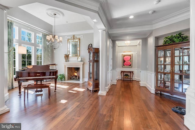 22577 Creighton Farms Dr, Leesburg, VA 20175 - entryway featuring ornamental molding, ornate columns, a chandelier, and wood finished floors