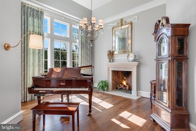 22577 Creighton Farms Dr, Leesburg, VA 20175 - living area with a fireplace, a notable chandelier, baseboards, and wood finished floors