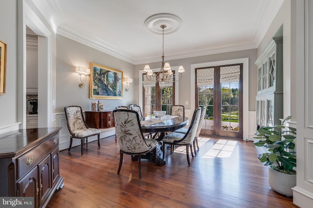 22577 Creighton Farms Dr, Leesburg, VA 20175 - dining space with a notable chandelier, dark wood-style flooring, and crown molding
