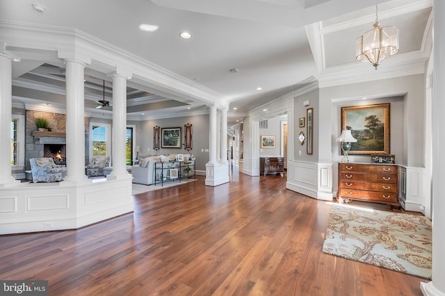 22577 Creighton Farms Dr, Leesburg, VA 20175 - foyer entrance featuring wood finished floors, decorative columns, a stone fireplace, and recessed lighting
