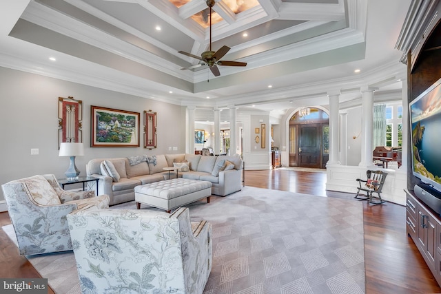 22577 Creighton Farms Dr, Leesburg, VA 20175 - living room with a towering ceiling, a ceiling fan, crown molding, decorative columns, and wood finished floors