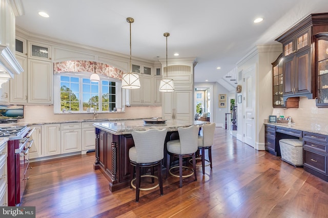22577 Creighton Farms Dr, Leesburg, VA 20175 - kitchen featuring high end stainless steel range oven, tasteful backsplash, plenty of natural light, and dark wood finished floors