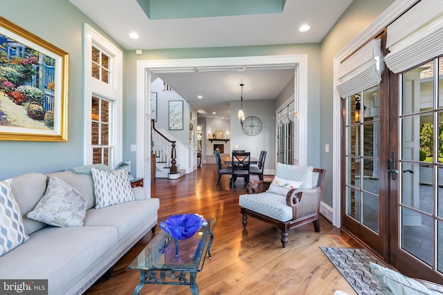 22577 Creighton Farms Dr, Leesburg, VA 20175 - living area with recessed lighting, wood finished floors, stairs, french doors, and baseboards