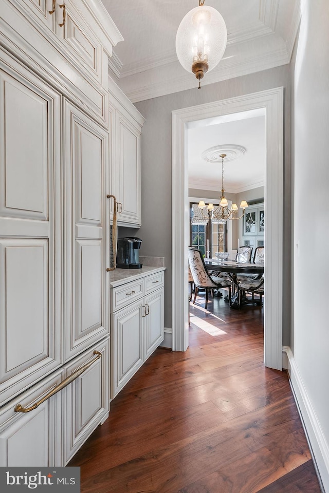 22577 Creighton Farms Dr, Leesburg, VA 20175 - hall featuring dark wood-style flooring, baseboards, an inviting chandelier, and crown molding