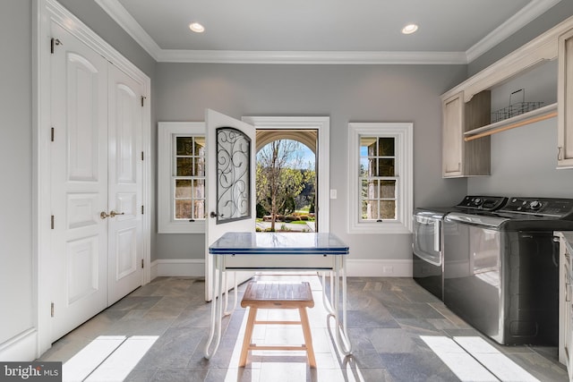 22577 Creighton Farms Dr, Leesburg, VA 20175 - washroom with cabinet space, baseboards, washing machine and dryer, and stone tile floors