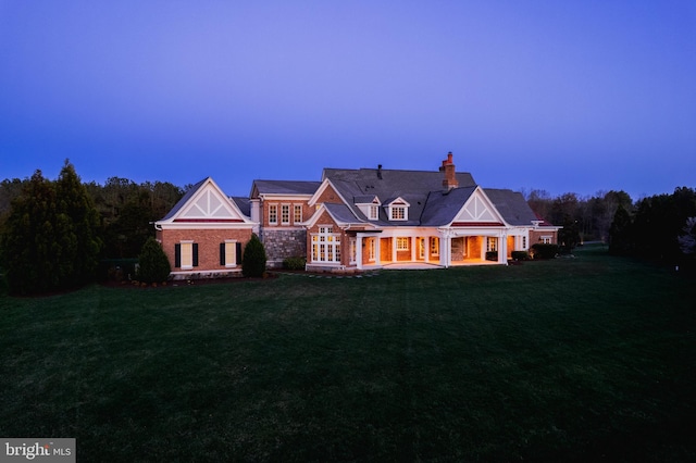 22577 Creighton Farms Dr, Leesburg, VA 20175 - back of house with a chimney and a lawn