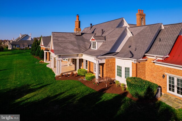 22577 Creighton Farms Dr, Leesburg, VA 20175 - rear view of property featuring a patio area, brick siding, a chimney, and a lawn