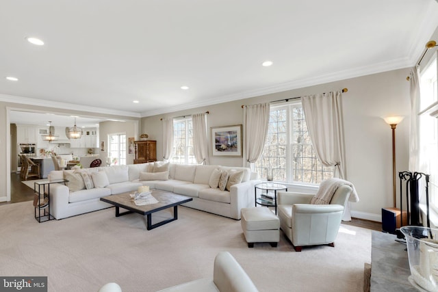 living room featuring baseboards, recessed lighting, and crown molding