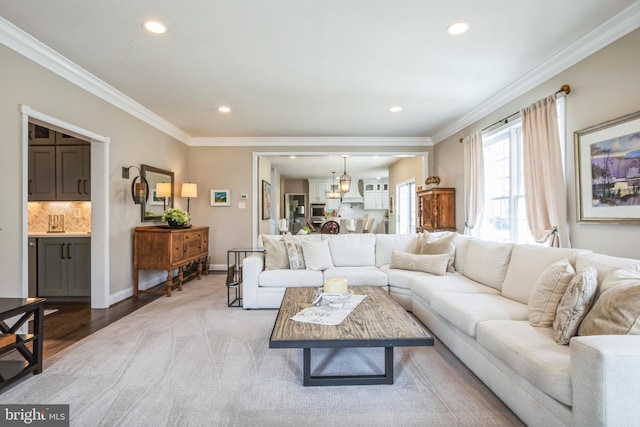 living room featuring ornamental molding, recessed lighting, light wood-style floors, and baseboards