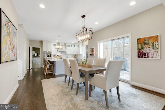 dining space featuring dark wood-type flooring, recessed lighting, and baseboards