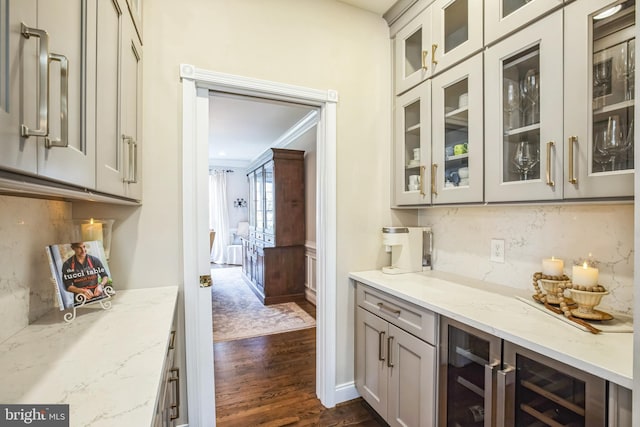 bar with beverage cooler, dark wood-style flooring, decorative backsplash, and crown molding