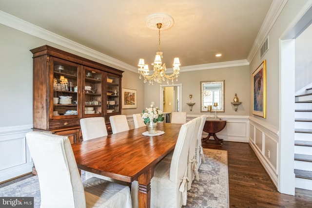 dining area with a decorative wall, visible vents, stairway, dark wood-style floors, and an inviting chandelier