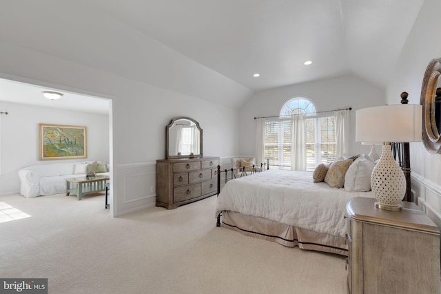 bedroom with light colored carpet, lofted ceiling, a wainscoted wall, a decorative wall, and recessed lighting