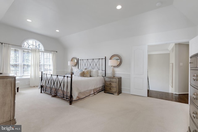 bedroom with light carpet, recessed lighting, and lofted ceiling