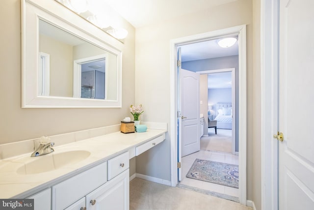 bathroom featuring baseboards, vanity, and tile patterned floors