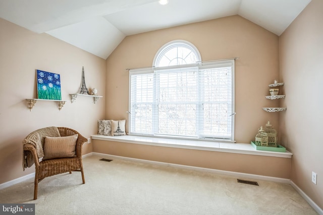 sitting room featuring lofted ceiling, carpet, visible vents, and baseboards