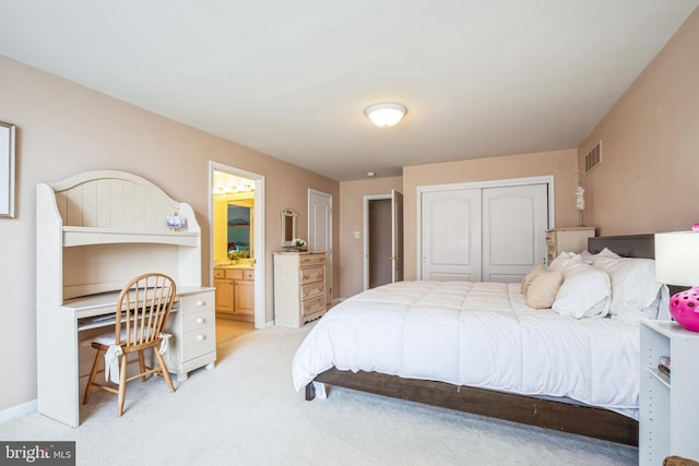 bedroom with a closet, light colored carpet, visible vents, connected bathroom, and baseboards