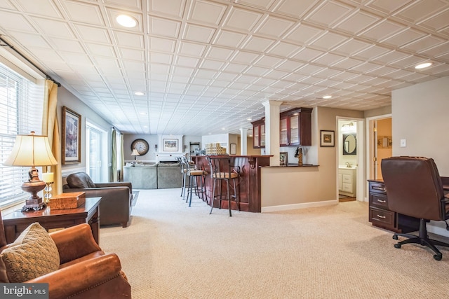 interior space featuring light carpet, a dry bar, baseboards, and recessed lighting