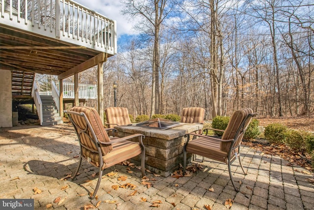 view of patio featuring a fire pit and stairs