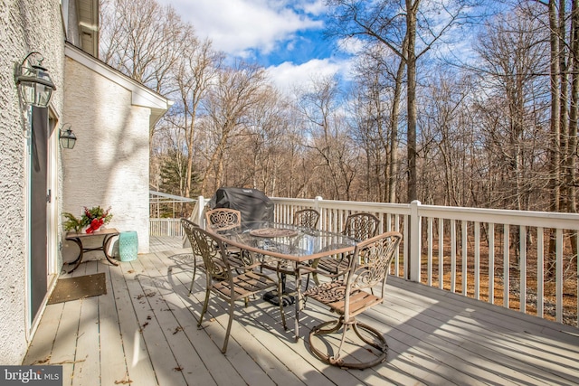 wooden terrace featuring outdoor dining space