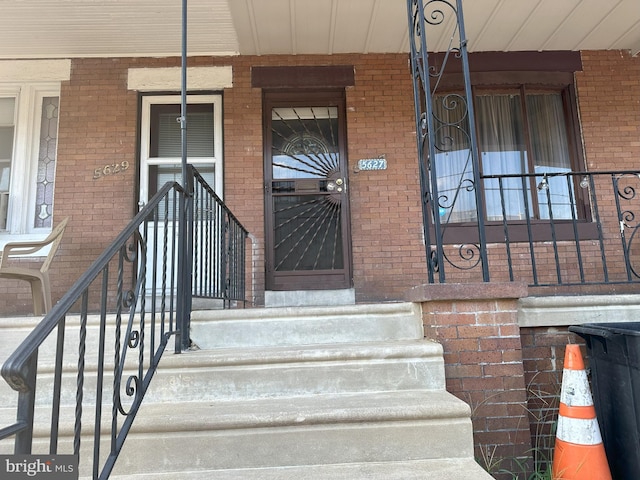 property entrance featuring brick siding