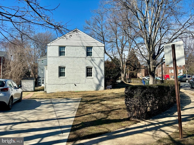 view of side of home featuring brick siding