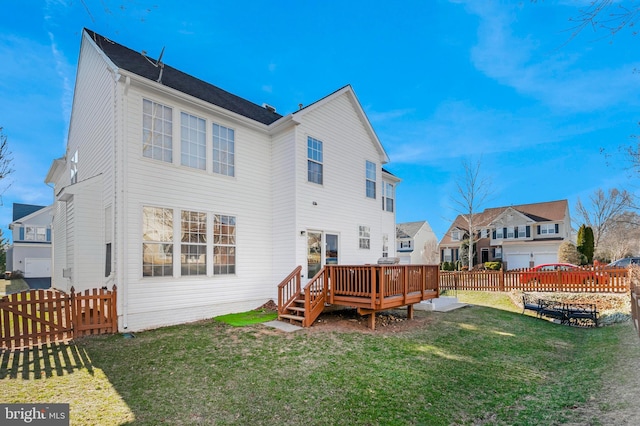 back of house with a yard, a fenced backyard, and a wooden deck