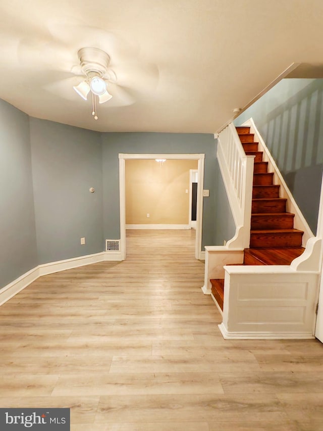 interior space featuring visible vents, baseboards, and wood finished floors