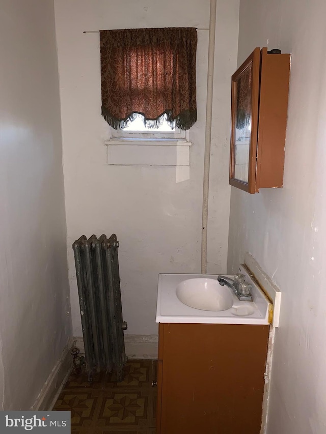 bathroom featuring radiator and vanity