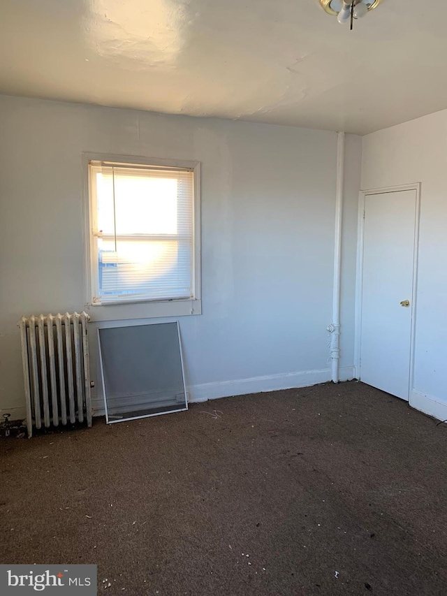 unfurnished room with radiator