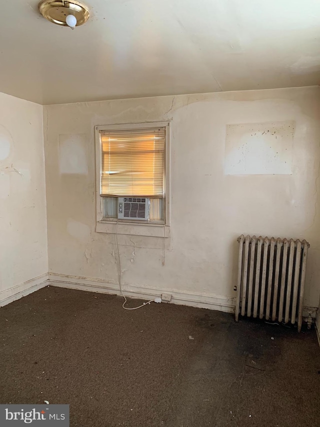 unfurnished room featuring cooling unit and radiator