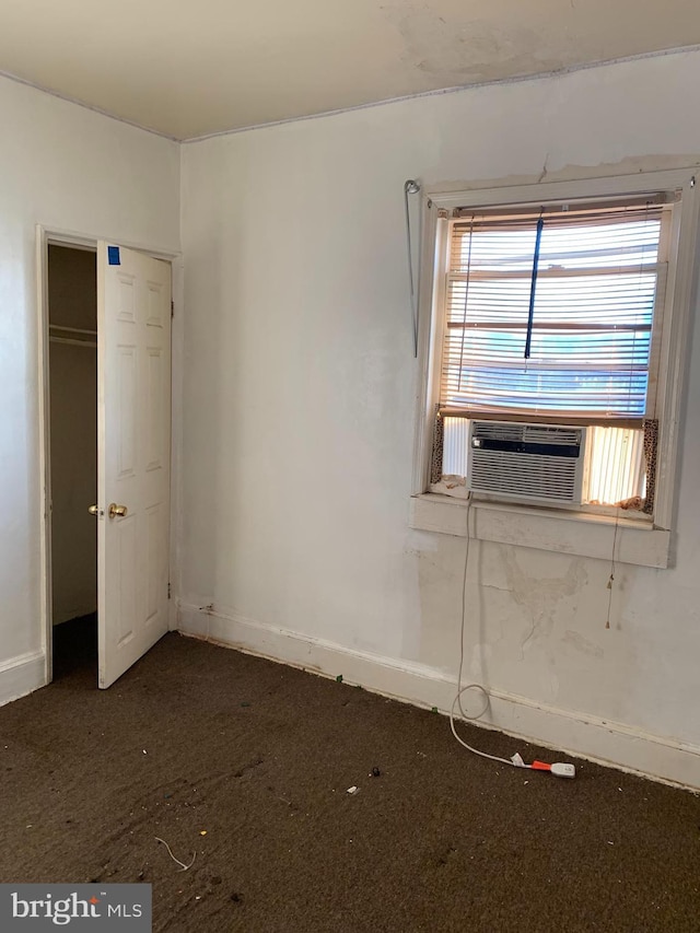 spare room with cooling unit and baseboards