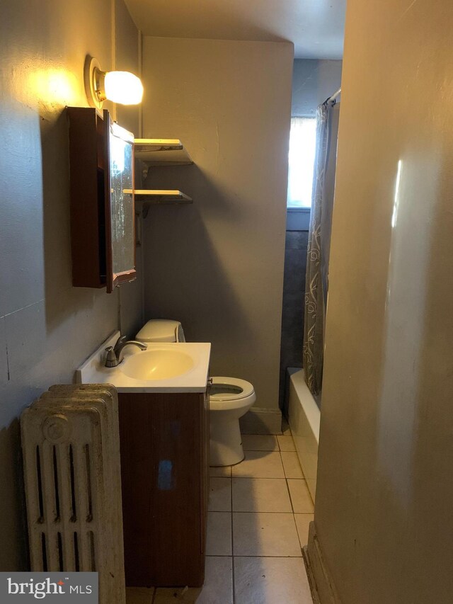 bathroom with tile patterned floors, toilet, vanity, and shower / bath combo