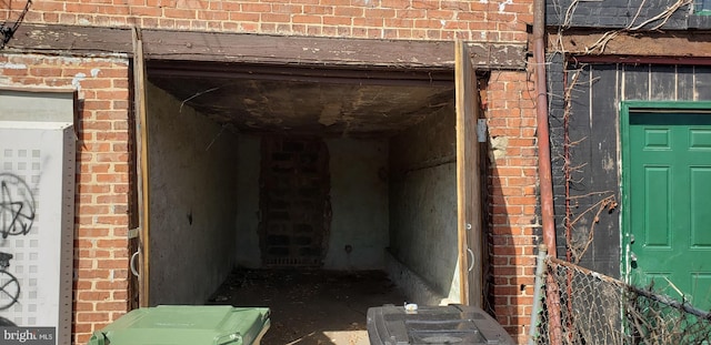 property entrance featuring brick siding