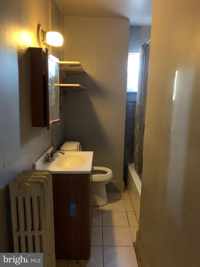 full bathroom with tile patterned floors, shower / tub combo, toilet, and vanity