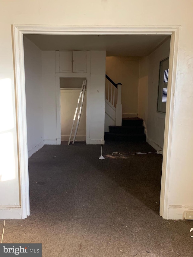 hallway with stairs and carpet