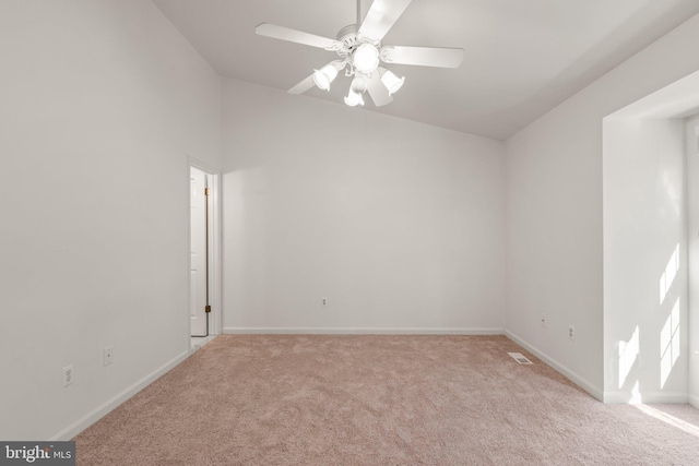 spare room featuring a ceiling fan, carpet flooring, visible vents, and baseboards