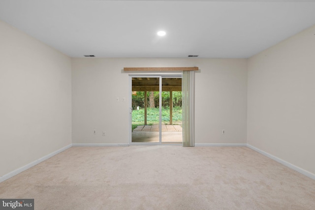 unfurnished room featuring carpet flooring, visible vents, and baseboards