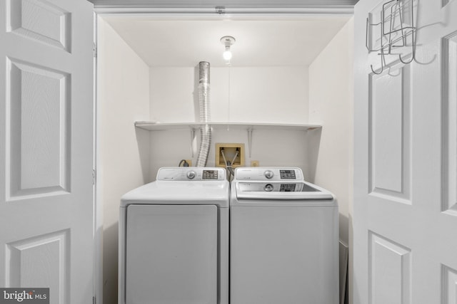 clothes washing area featuring laundry area and separate washer and dryer