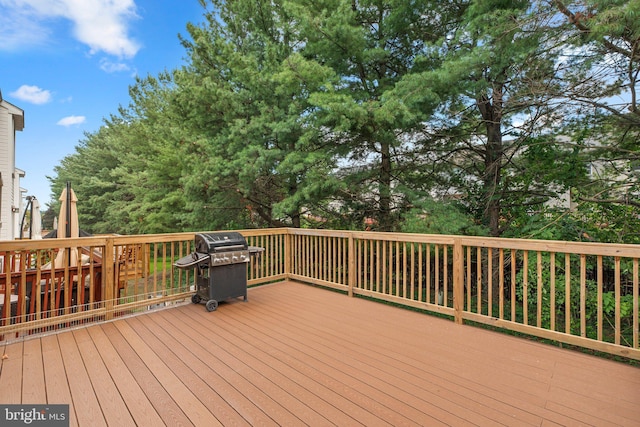 wooden deck with a grill