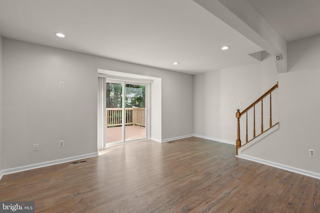 unfurnished living room featuring recessed lighting, baseboards, and wood finished floors