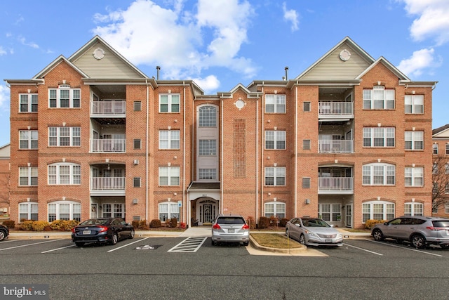 view of building exterior featuring uncovered parking