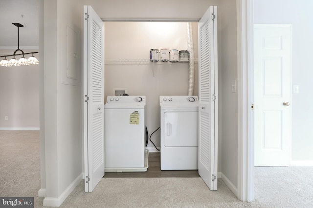 laundry room with carpet, laundry area, washing machine and dryer, and baseboards