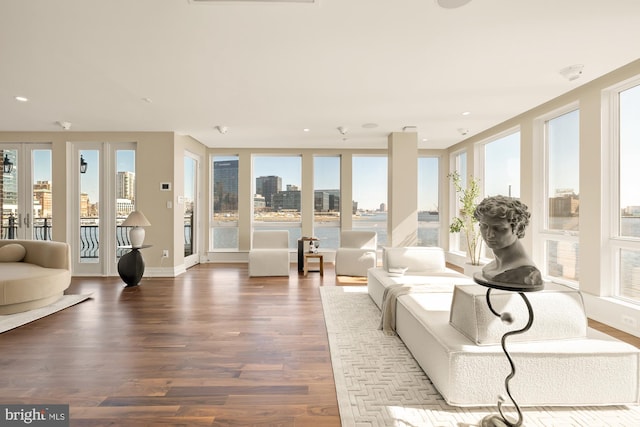 sunroom / solarium with a city view and french doors