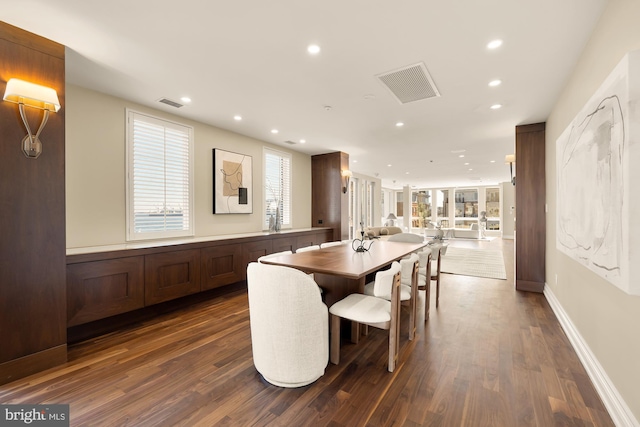 dining room with dark wood-type flooring, recessed lighting, and visible vents