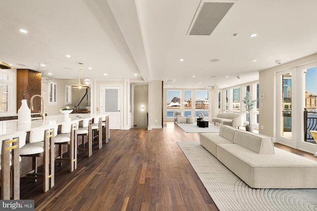 living room featuring recessed lighting, visible vents, baseboards, stairs, and dark wood-style floors