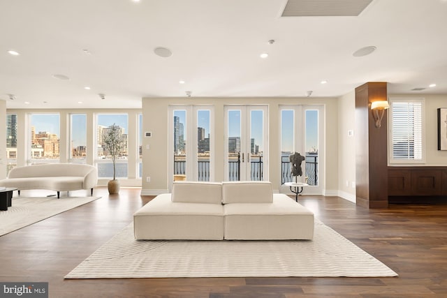 living room featuring a view of city, visible vents, recessed lighting, and wood finished floors